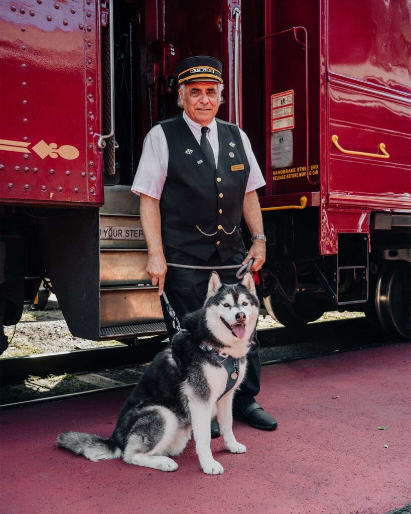 Train conductor standing with a Siberian Husky at Lehigh Gorge Scenic Railway